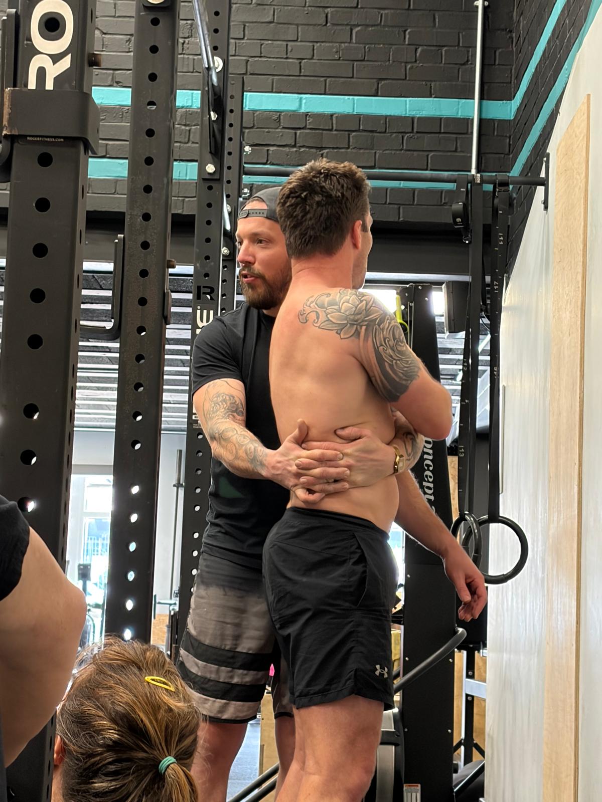 Spotting and coaching a client at XGym